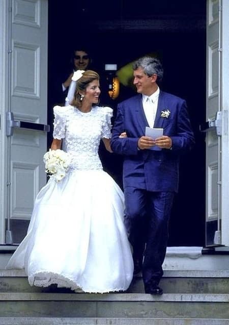 Caroline at her wedding. Donned in a beautiful white bride dress with husband on blue tuxedo.